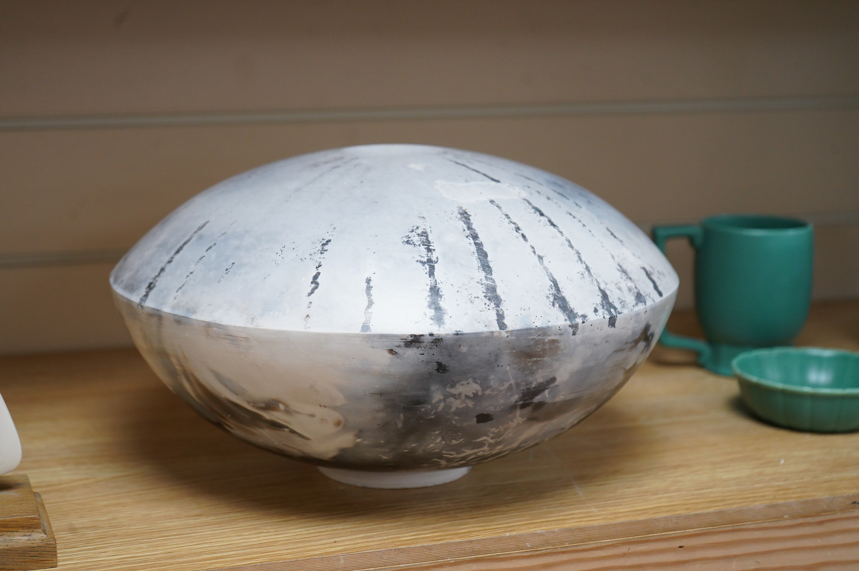 David Harrison (Modern British) a pit fired pottery vase of circular squat form, incised initials to the base, 31cm in diameter